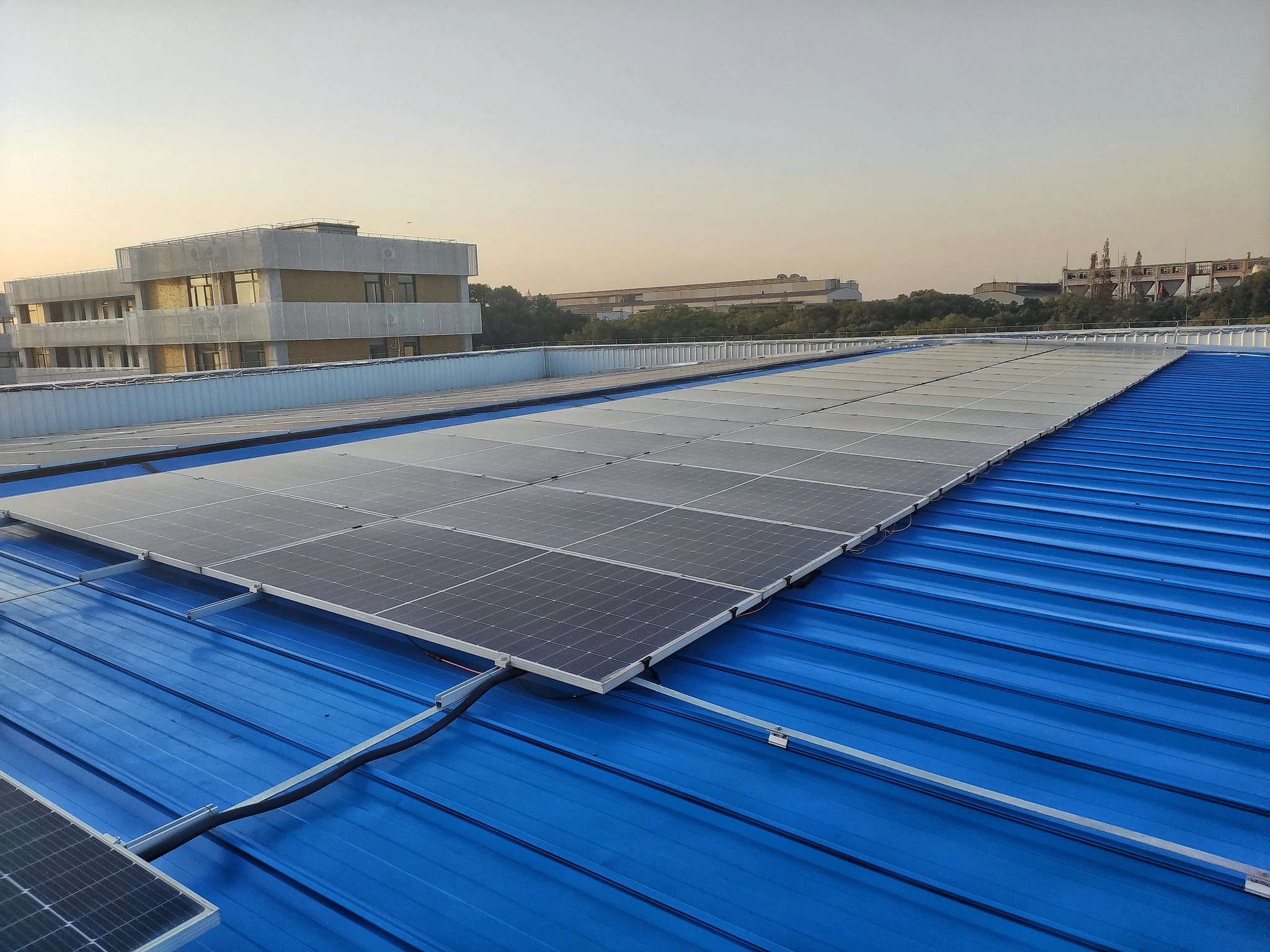 Solar modules installed on the blue metal roof of the Minhang factory in Shanghai